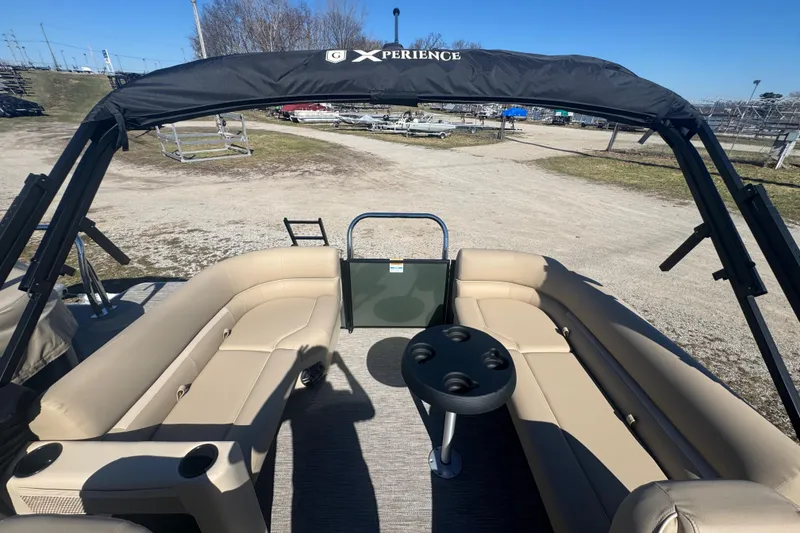 Slide: The Image of 2026 Godfrey Xperience 2286 SBX pontoon boat with beige seating and black canopy. - 23