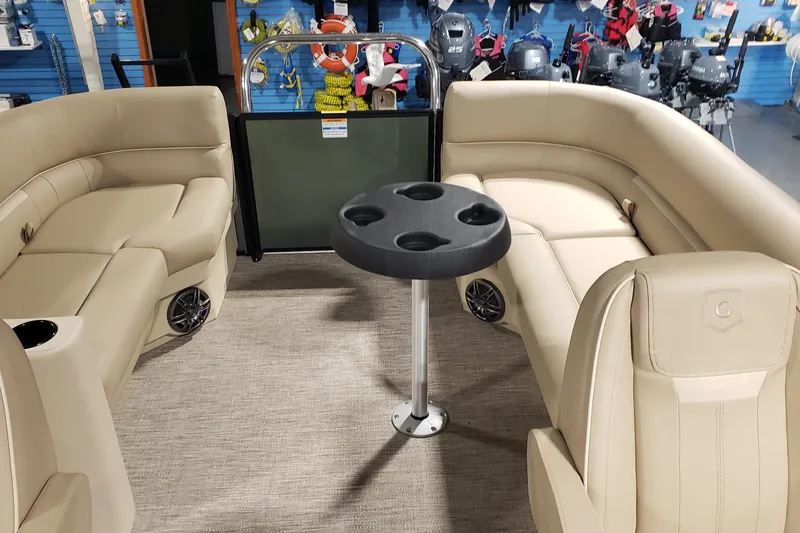Slide: The Image of Luxurious Sweetwater EX2286SBX 2026 pontoon boat interior with beige seating and cupholder table. - 6