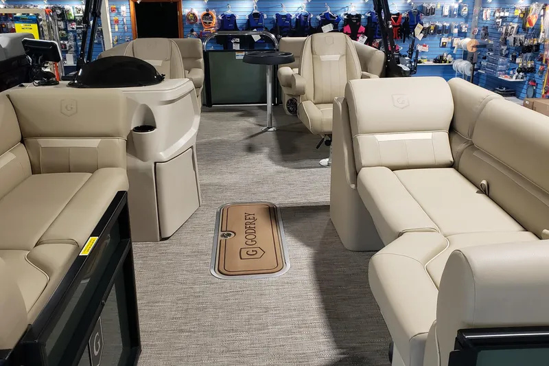 Slide: The Image of Luxurious interior of 2026 Sweetwater EX2286SBX pontoon boat with beige seating. - 7