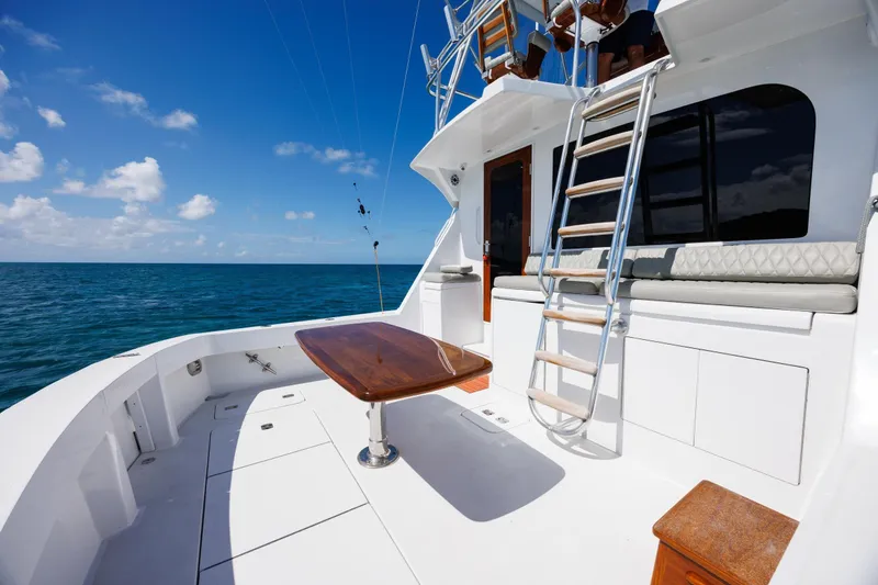 Slide: The Image of 2005 Hatteras 50 Convertible yacht deck with ladder and ocean view. - 10