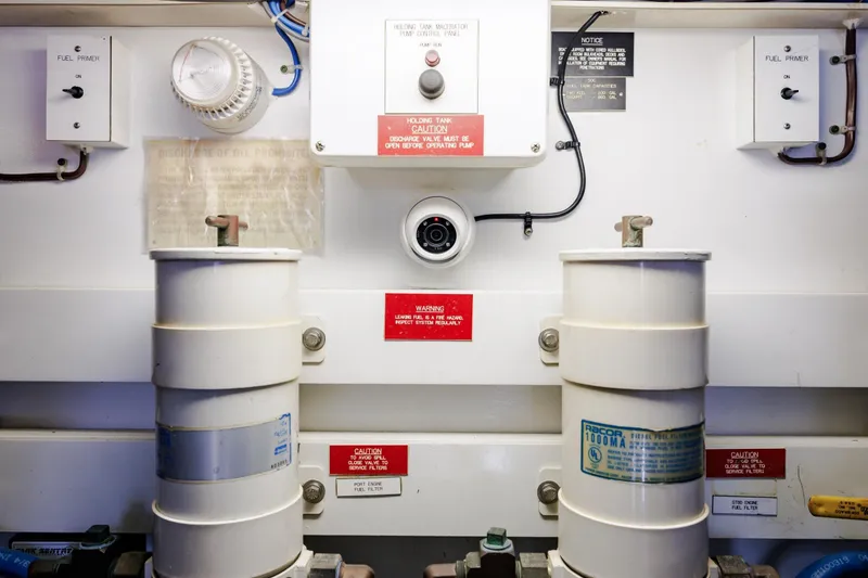 Slide: The Image of Engine room of 2005 Hatteras 50 Convertible with fuel filters and control panels. - 100