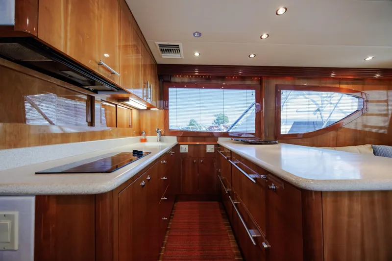 Slide: The Image of Luxurious kitchen interior of 2005 Hatteras 50 Convertible yacht with wood cabinetry and modern appliances. - 12