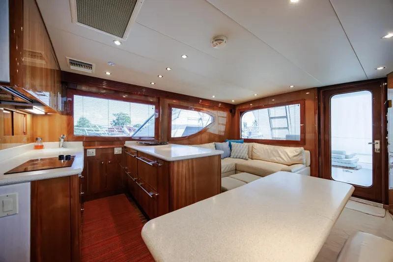 Slide: The Image of Luxurious interior of 2005 Hatteras 50 Convertible yacht with modern kitchen and seating area. - 15