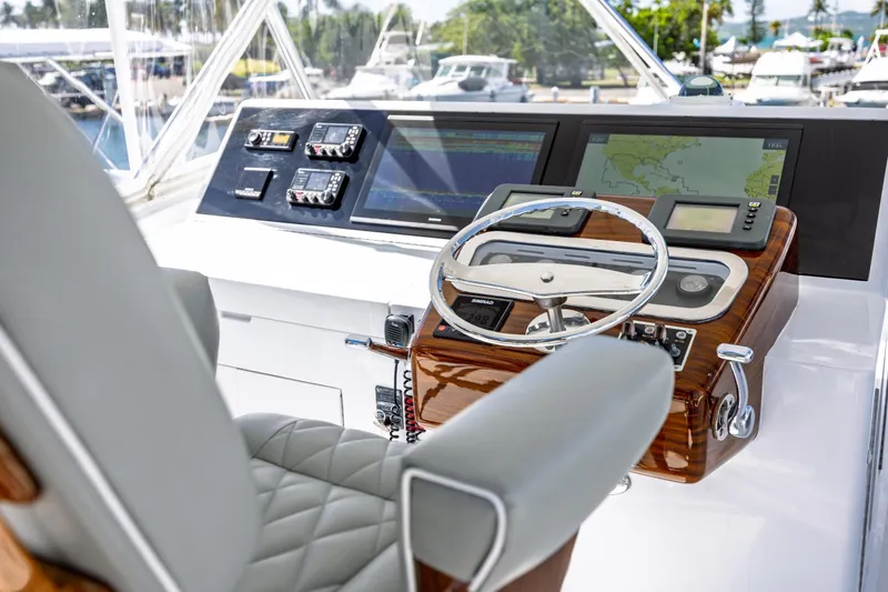 Slide: The Image of Helm of 2005 Hatteras 50 Convertible yacht with navigation equipment and steering wheel. - 2