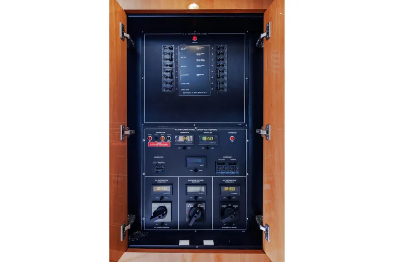 Slide: The Image of Electrical panel inside 2005 Hatteras 50 Convertible yacht, featuring switches and controls. - 26