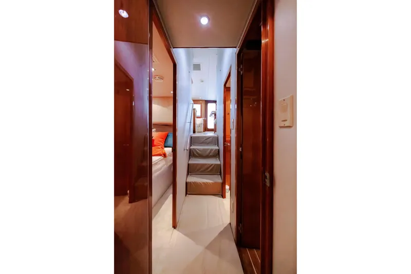 Slide: The Image of Interior hallway of 2005 Hatteras 50 Convertible yacht with wooden finishes and stairs. - 29