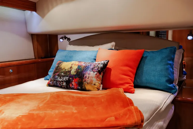 Slide: The Image of Luxurious cabin interior of 2005 Hatteras 50 Convertible yacht with vibrant pillows and bedding. - 30