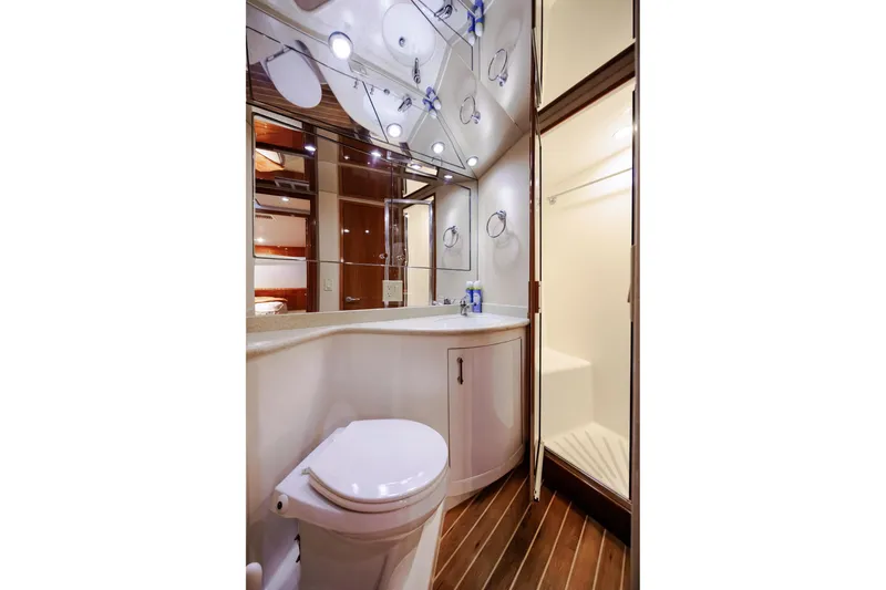 Slide: The Image of Luxurious bathroom in 2005 Hatteras 50 Convertible yacht with modern fixtures and wood flooring. - 35