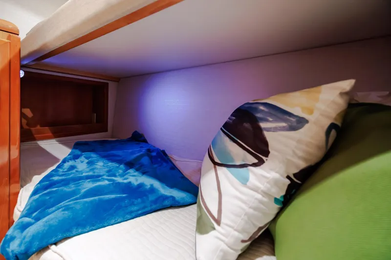 Slide: The Image of Cozy cabin bed with colorful pillows and blanket on 2005 Hatteras 50 Convertible yacht. - 46