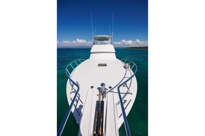 Slide: The Image of Bow view of 2005 Hatteras 50 Convertible yacht on clear blue water. - 49