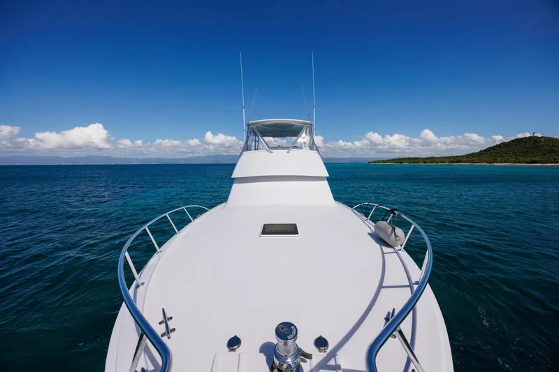 Slide: The Image of Bow view of 2005 Hatteras 50 Convertible yacht on clear blue ocean. - 50