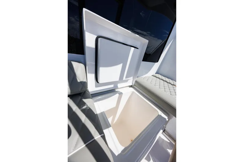 Slide: The Image of Open storage compartment on 2005 Hatteras 50 Convertible yacht, featuring cushioned seating. - 52