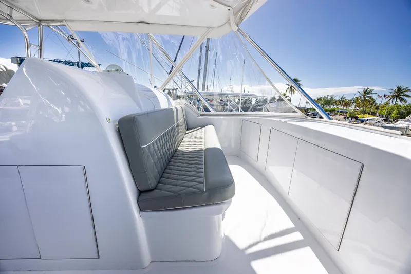 Slide: The Image of Luxurious seating area on a 2005 Hatteras 50 Convertible yacht, with marina view. - 54