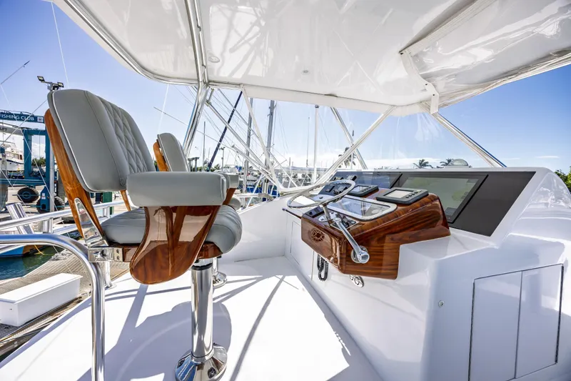Slide: The Image of Helm of 2005 Hatteras 50 Convertible yacht with luxurious seating and controls. - 58