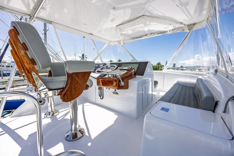 Slide: The Image of Luxurious helm of 2005 Hatteras 50 Convertible yacht with polished wood and leather seating. - 59