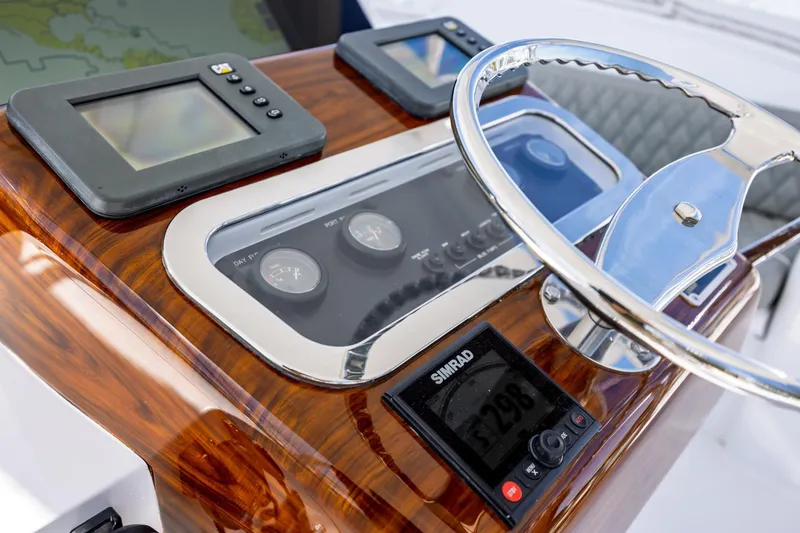 Slide: The Image of Helm of 2005 Hatteras 50 Convertible yacht with navigation instruments and steering wheel. - 61