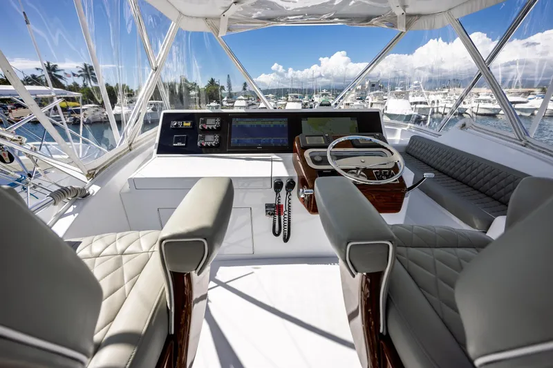 Slide: The Image of Helm of 2005 Hatteras 50 Convertible yacht with luxurious seating and navigation equipment. - 62