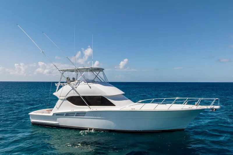 Slide: The Image of 2005 Hatteras 50 Convertible yacht on open sea under clear blue sky. - 71