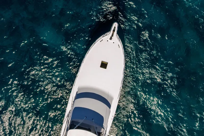 Slide: The Image of Aerial view of 2005 Hatteras 50 Convertible yacht on sparkling blue water. - 83
