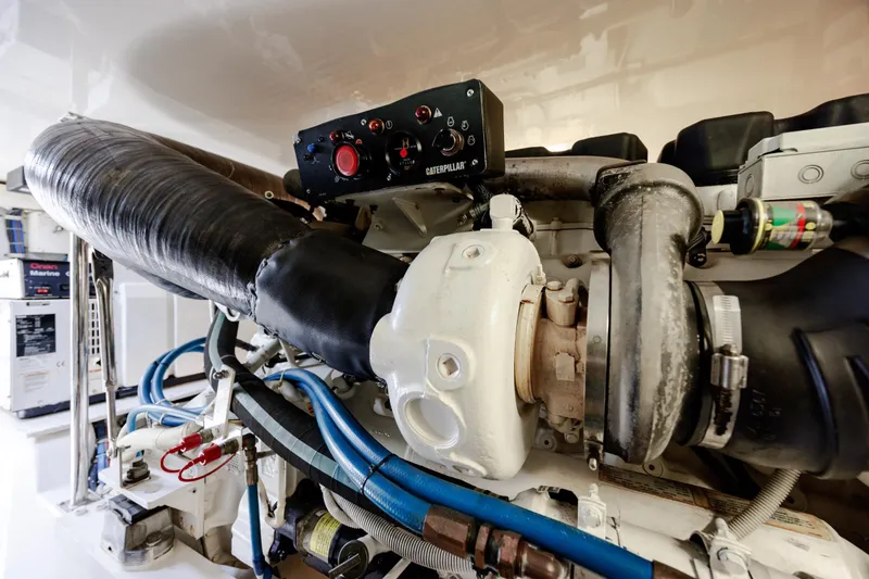 Slide: The Image of Engine room of 2005 Hatteras 50 Convertible yacht, featuring Caterpillar components and marine equipment. - 95