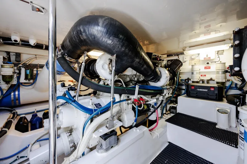 Slide: The Image of Engine room of 2005 Hatteras 50 Convertible yacht, featuring complex machinery and equipment. - 98