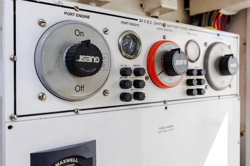 Slide: The Image of Control panel of a 2005 Hatteras 50 Convertible yacht, featuring engine and battery switches. - 99