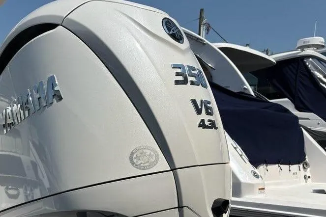 Slide: The Image of 2026 Regal 26 XO boat interior with white and gray seating and cup holder. - 11