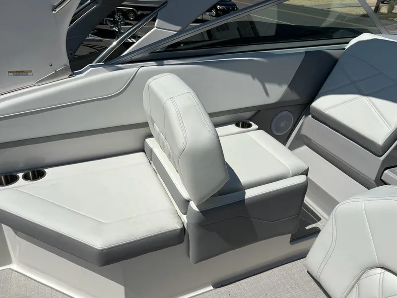 Slide: The Image of 2026 Regal 26 XO boat interior with modern dashboard and steering wheel in showroom. - 3