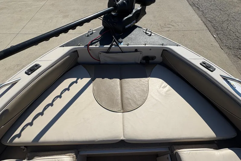 Slide: The Image of 2001 Crestliner 1900 PHANTOM SST boat interior with cushioned seating and Minn Kota trolling motor. - 15