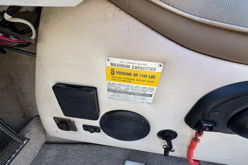 Slide: The Image of 2001 Crestliner 1900 PHANTOM SST boat interior with capacity label and control panel. - 23