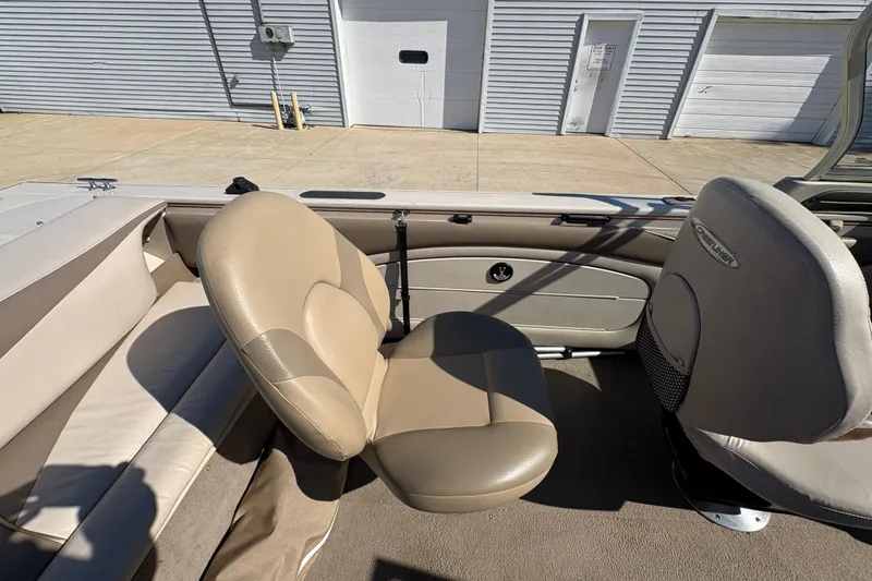 Slide: The Image of 2001 Crestliner 1900 PHANTOM SST boat interior with beige seating and storage compartments. - 27