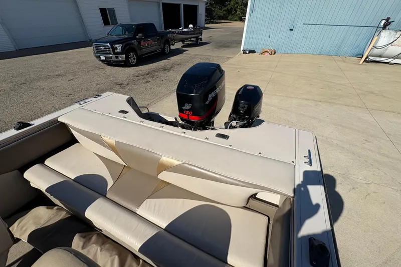 Slide: The Image of 2001 Crestliner 1900 PHANTOM SST boat with Mercury outboard motors, parked near a truck. - 31