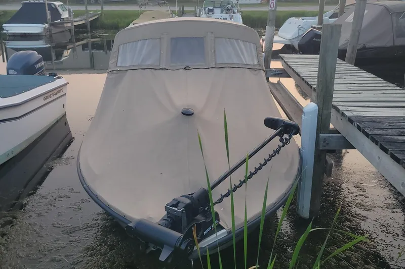Slide: The Image of 2001 Crestliner 1900 PHANTOM SST boat with cover, docked at marina. - 39