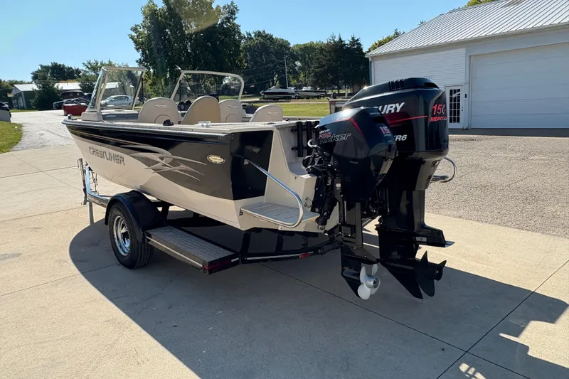 Slide: The Image of 2001 Crestliner 1900 PHANTOM SST boat on trailer, featuring Mercury outboard motor. - 4