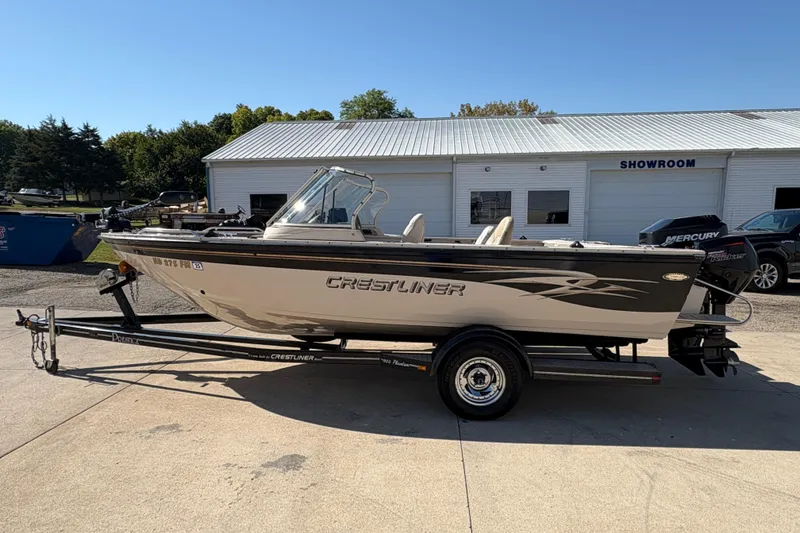 Slide: The Image of 2001 Crestliner 1900 PHANTOM SST boat on trailer outside showroom. - 5