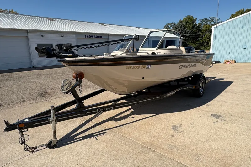 Slide: The Image of 2001 Crestliner 1900 PHANTOM SST boat on trailer outside showroom. - 6