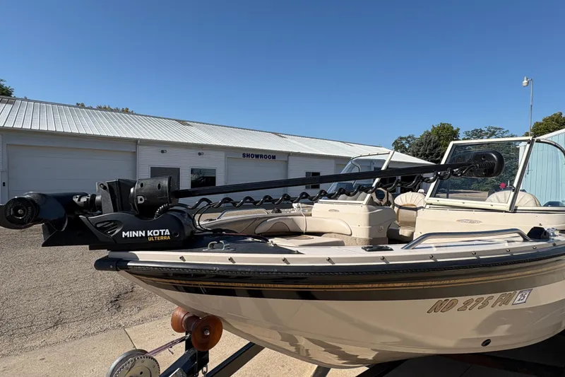 Slide: The Image of 2001 Crestliner 1900 PHANTOM SST boat with Minn Kota Ulterra motor, parked outside showroom. - 9