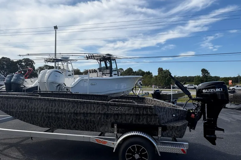 Slide: The Image of 2025 Edge Duck Boats 756DB with Suzuki outboard motor on trailer, parked outdoors. - 3