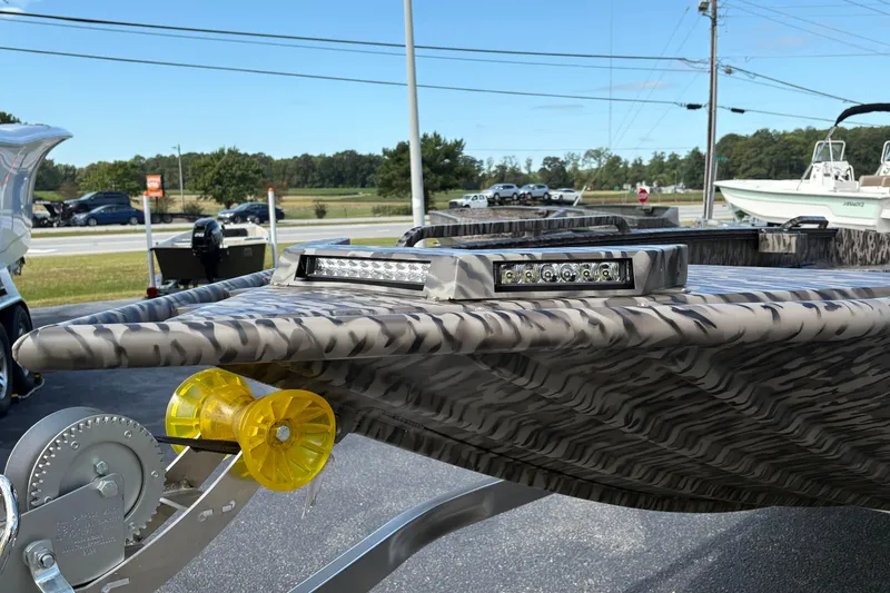Slide: The Image of 2025 Edge Duck Boats 756DB with camo design and LED lights on trailer. - 4