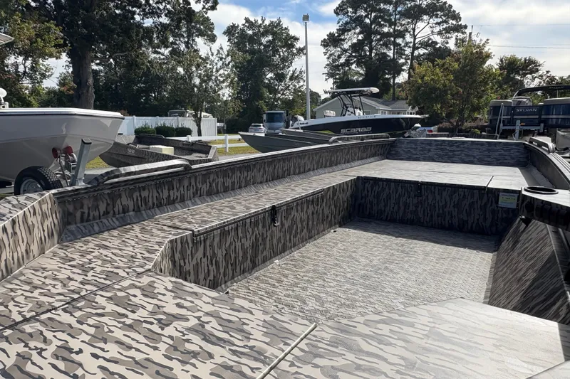 Slide: The Image of 2025 Edge Duck Boats 756DB with camouflage design, parked outdoors. - 5