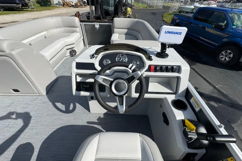 Slide: The Image of 2026 Sweetwater EX2286SBX boat interior with steering wheel and seating. - 10