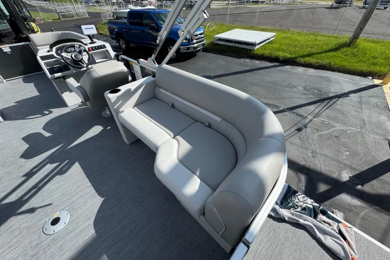 Slide: The Image of 2026 Sweetwater EX2286SBX pontoon boat interior with gray seating and steering console. - 11