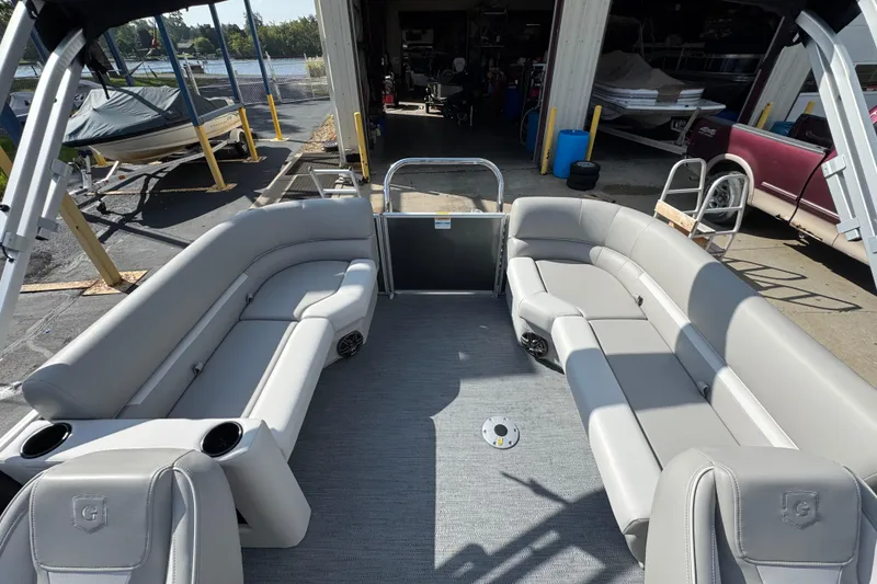 Slide: The Image of 2026 Sweetwater EX2286SBX pontoon boat interior with gray seating and spacious layout. - 12