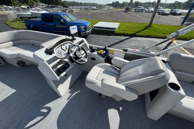 Slide: The Image of Interior of 2026 Sweetwater EX2286SBX pontoon boat with modern steering console and seating. - 9