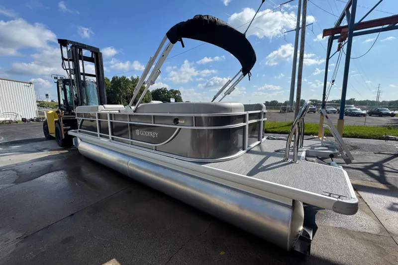 Slide: The Image of 2026 Sweetwater EX2286SBX pontoon boat on forklift, outdoor setting, sunny day. - 3