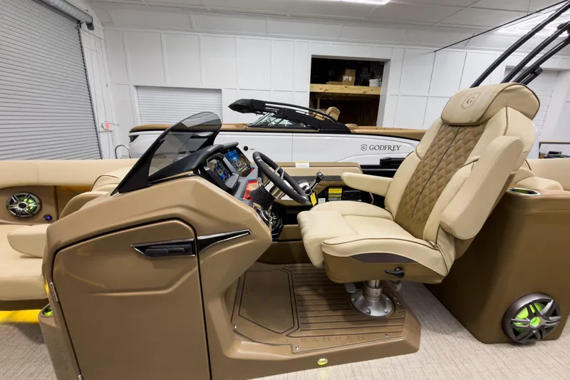 Slide: The Image of Luxurious interior of 2026 Godfrey Sanpan 23' Ultra Lounge Tritoon with plush captain's chair. - 18