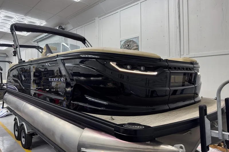 Slide: The Image of 2026 Godfrey Sanpan 23' Ultra Lounge Tritoon in a workshop. - 2