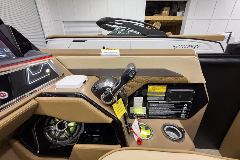 Slide: The Image of Interior view of 2026 Godfrey Sanpan 23' Ultra Lounge Tritoon, showcasing controls and seating. - 25