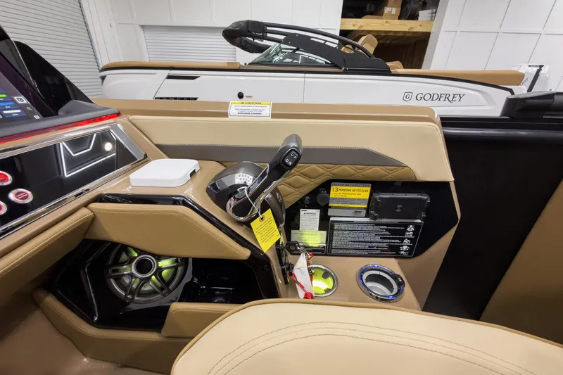 Slide: The Image of Interior of 2026 Godfrey Sanpan 23' Ultra Lounge Tritoon, featuring modern controls and luxurious seating. - 26