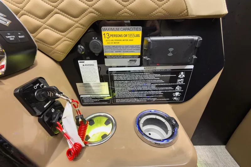 Slide: The Image of Control panel of 2026 Godfrey Sanpan 23' Ultra Lounge Tritoon with safety warnings and cup holder. - 27